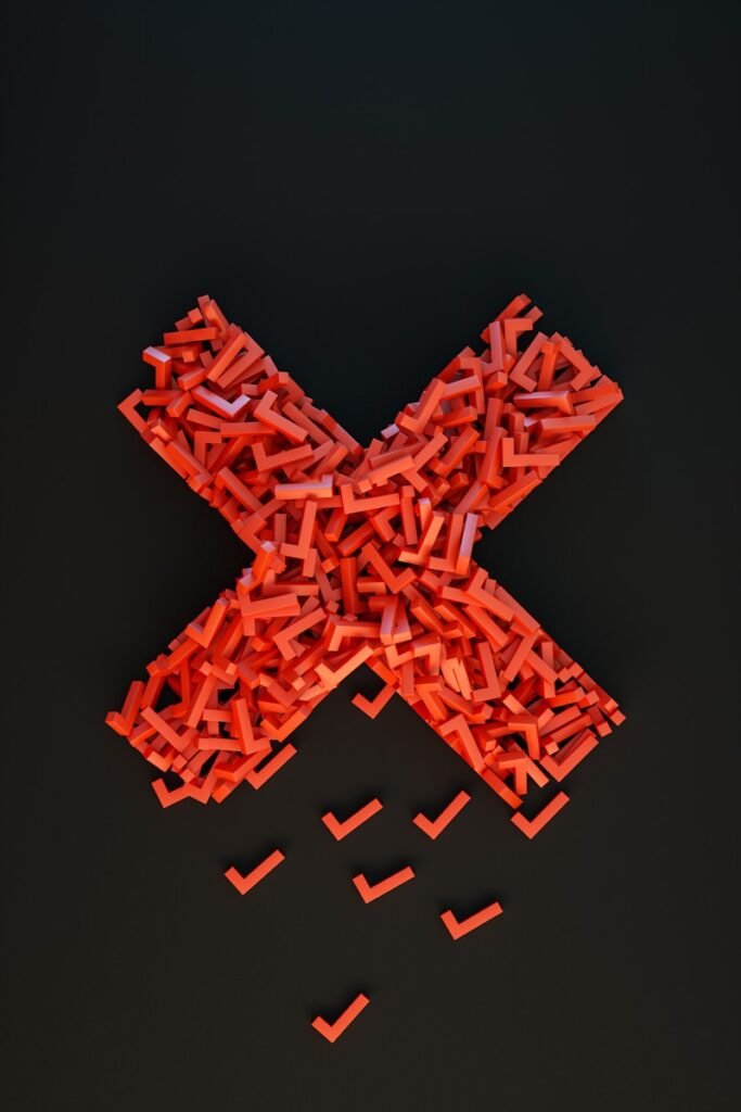 a cross made out of small pieces of red plastic