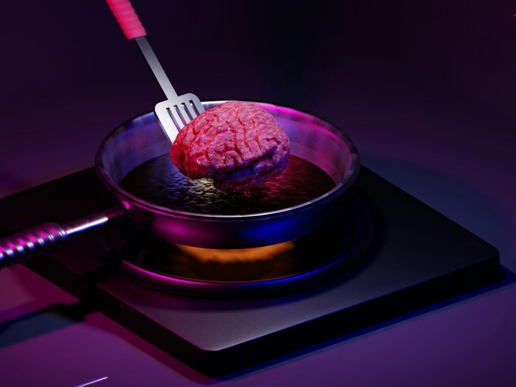 a pink brain in a bowl with a fork in it