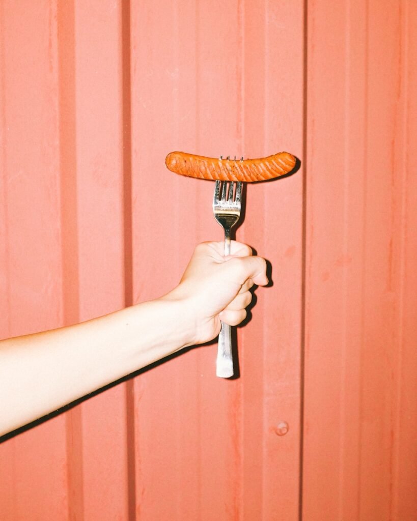 person holding brown wooden handle